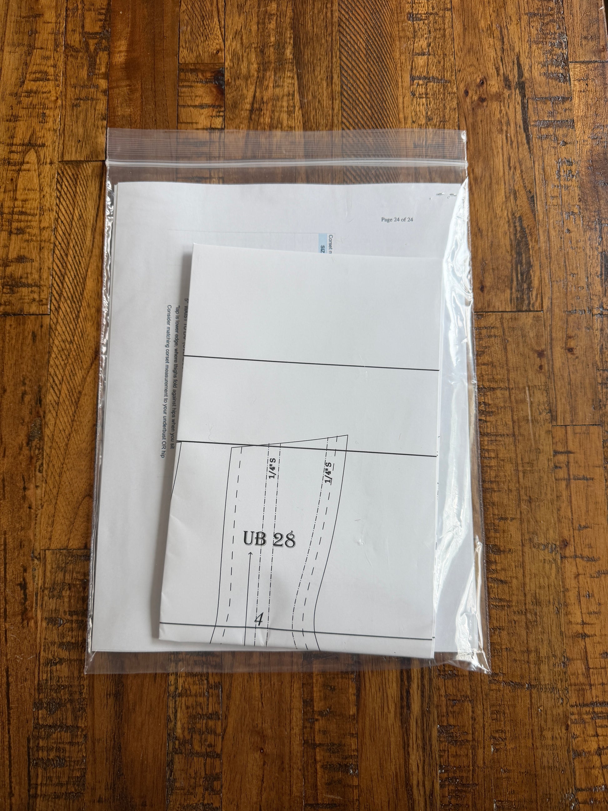 White paper with measurements on a clear plastic bag over a wooden surface