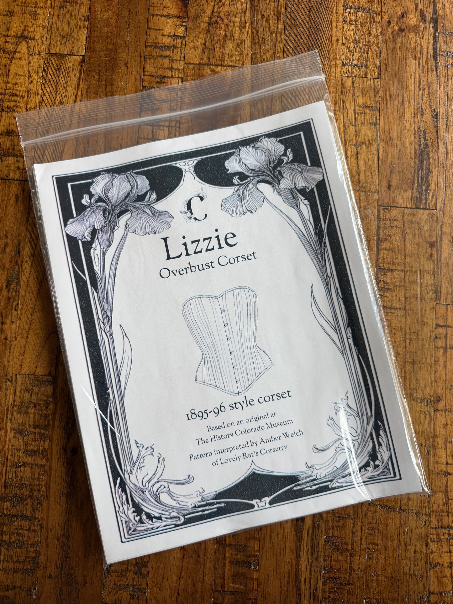 Package of Lizzie Overbust Corset pattern on a wooden surface