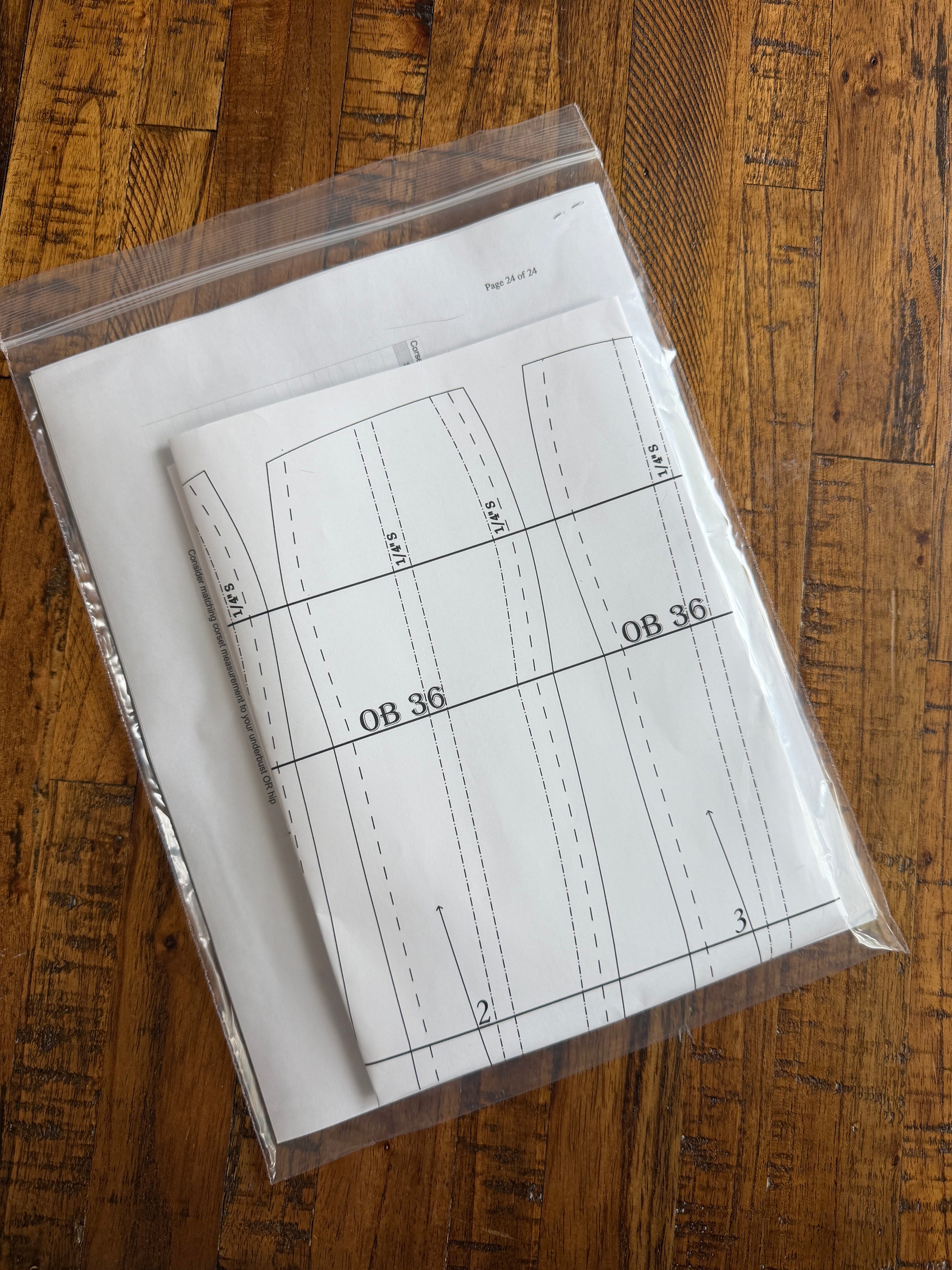 Sheet of paper with technical drawings or measurements on a wooden surface