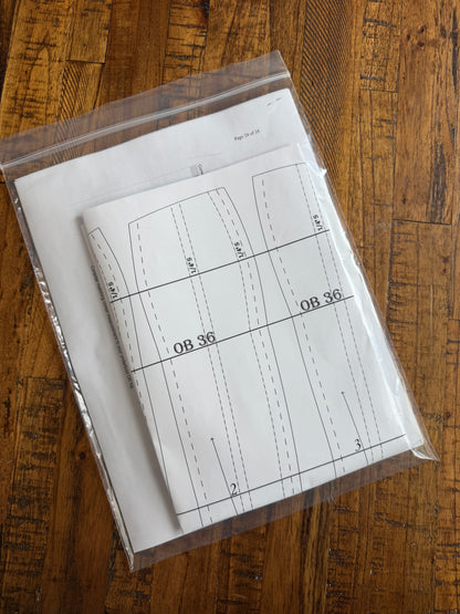Sheet of paper with technical drawings or measurements on a wooden surface